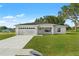 Newly constructed single-story home with a two-car garage and landscaped lawn at 17273 Sw 20Th Court Rd, Ocala, FL 34473