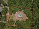 Aerial shot with a red outline of a single-story home and pool nestled in the woods at 15235 Se 63Rd Ave, Summerfield, FL 34491