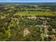 Aerial view of property boundaries with a single-story house and pool surrounded by mature trees at 15235 Se 63Rd Ave, Summerfield, FL 34491