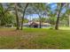 Spacious backyard with mature trees surrounding the single-story home at 15235 Se 63Rd Ave, Summerfield, FL 34491