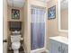 Cozy bathroom features a walk-in shower, light blue vanity, and charming Batman comic art on the wall at 15235 Se 63Rd Ave, Summerfield, FL 34491