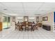 Bright dining room with sliding door, featuring a large table set and abundant natural light at 15235 Se 63Rd Ave, Summerfield, FL 34491