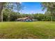 Charming single-story home with a brick facade, screened in porch, and spacious front lawn at 15235 Se 63Rd Ave, Summerfield, FL 34491