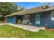 Inviting front porch features blue painted brick, charming bench, and an accenting yellow chair at 15235 Se 63Rd Ave, Summerfield, FL 34491