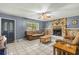 Inviting living room with a stone fireplace, neutral furnishings, and tile flooring at 15235 Se 63Rd Ave, Summerfield, FL 34491