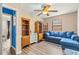 Versatile living room featuring blue sectional seating and wood-look floors, designed for relaxation and functionality at 15235 Se 63Rd Ave, Summerfield, FL 34491