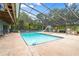 Inviting screened-in pool with slide, plenty of deck space, and outdoor seating at 15235 Se 63Rd Ave, Summerfield, FL 34491