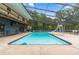 Large screened-in pool with slide and spacious deck area for relaxing and entertaining at 15235 Se 63Rd Ave, Summerfield, FL 34491