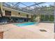 Expansive screened-in pool area with pool slide and ample lounging space at 15235 Se 63Rd Ave, Summerfield, FL 34491