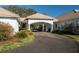 Elegant home driveway with covered entrance and lush landscaping at 3440 Sw 66Th St, Ocala, FL 34476