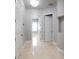 Light and airy hallway with tile flooring and access to multiple rooms at 3440 Sw 66Th St, Ocala, FL 34476