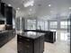 Spacious kitchen boasts dark cabinetry, granite island, and high-end appliances at 3440 Sw 66Th St, Ocala, FL 34476