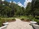 Brick pathway meanders through a scenic landscape with oak trees at 3440 Sw 66Th St, Ocala, FL 34476