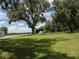 Large grassy yard with mature oak trees and a detached garage at 3440 Sw 66Th St, Ocala, FL 34476