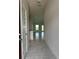 Bright entryway with gray tile flooring leading into the open-concept living area and kitchen at 4509 Sw 90Th Pl, Ocala, FL 34476