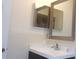 Bathroom vanity with white sink and mirror at 10926 Sw 78Th Ct, Ocala, FL 34476