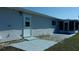 A view of the back of the property with a grey patio and door for access to outside at 10926 Sw 78Th Ct, Ocala, FL 34476