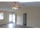 Open living room with a ceiling fan and door leading outside at 10926 Sw 78Th Ct, Ocala, FL 34476