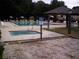 Community pool and spa with lounge chairs and umbrellas at 10926 Sw 78Th Ct, Ocala, FL 34476