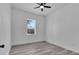 White bedroom features a ceiling fan and a window at 35 Locust Terrace Way, Ocala, FL 34472