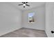 Bright bedroom with ceiling fan and a sunlit window view at 35 Locust Terrace Way, Ocala, FL 34472