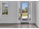 Bright entryway featuring a glass front door with sidelights, showcasing a view of the front yard at 35 Locust Terrace Way, Ocala, FL 34472