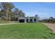 Inviting single-story home with a dark-colored garage door and lush green lawn at 35 Locust Terrace Way, Ocala, FL 34472