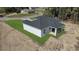 Rear view of new home with gray shingles, white siding and a covered patio at 35 Locust Terrace Way, Ocala, FL 34472