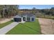 Exterior shot of a well-maintained single-story home with a long driveway and newly seeded lawn at 35 Locust Terrace Way, Ocala, FL 34472