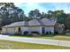 Three-car garage and a beautifully landscaped yard at 5894 Ne 43Rd Lane Rd, Silver Springs, FL 34488