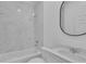 Bathroom with marble-look shower surround and a black framed mirror at 5394 Nw 6Th Pl, Ocala, FL 34482