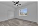 Empty bedroom with a ceiling fan, closet, and a view to the outdoors at 5394 Nw 6Th Pl, Ocala, FL 34482