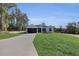 Inviting single-Gathering home showcasing a dark-colored garage door and fresh green lawn at 5394 Nw 6Th Pl, Ocala, FL 34482