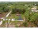 Stunning aerial view of home nestled on a spacious lot with mature trees and a long driveway at 4444 Sw 118 Ter, Ocala, FL 34481