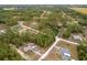 Aerial view showcasing a home in a serene setting, surrounded by lush greenery and mature trees at 4444 Sw 118 Ter, Ocala, FL 34481