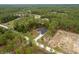 Scenic aerial view of a modern home nestled among lush greenery with a private driveway at 4444 Sw 118 Ter, Ocala, FL 34481