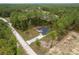 Aerial view of a property with long driveway surrounded by trees in a serene location at 4444 Sw 118 Ter, Ocala, FL 34481