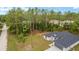 An aerial view of a modern home featuring an attached two-car garage and lush landscaping at 4444 Sw 118 Ter, Ocala, FL 34481