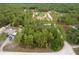 Aerial view capturing a home surrounded by tall trees, offering privacy and a scenic environment at 4444 Sw 118 Ter, Ocala, FL 34481