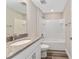 Modern bathroom boasts granite vanity top and shower-tub combination at 4444 Sw 118 Ter, Ocala, FL 34481
