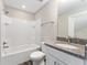 This light-filled bathroom has vinyl floors and a shower-tub combination at 4444 Sw 118 Ter, Ocala, FL 34481