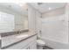 Modern bathroom boasts granite vanity top and shower-tub combination at 4444 Sw 118 Ter, Ocala, FL 34481