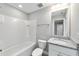 Bathroom with white subway tile, granite countertop and white cabinets at 4444 Sw 118 Ter, Ocala, FL 34481