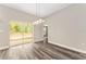 Bright dining room with sliding glass door and modern light fixture at 4444 Sw 118 Ter, Ocala, FL 34481