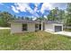 Single-story home with gray garage door and landscaping at 4444 Sw 118 Ter, Ocala, FL 34481