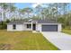 Charming single-story home featuring a gray roof and a well-manicured lawn at 4444 Sw 118 Ter, Ocala, FL 34481