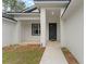 Inviting front porch with decorative plants and a walkway at 4444 Sw 118 Ter, Ocala, FL 34481