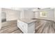 View of kitchen island, wood-look flooring, modern lighting, and living spaces at 4444 Sw 118 Ter, Ocala, FL 34481