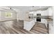Kitchen featuring a central island, stainless steel appliances, granite countertops, and wood-look floors at 4444 Sw 118 Ter, Ocala, FL 34481
