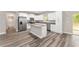 Bright kitchen features stainless steel appliances, granite countertops, and a center island at 4444 Sw 118 Ter, Ocala, FL 34481